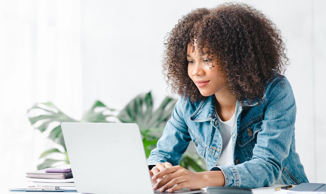 young woman looking at laptop